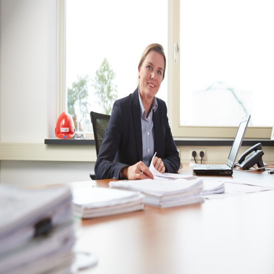 Aafke at her desk in the office