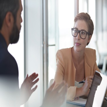 Co-workers talking together at office space
