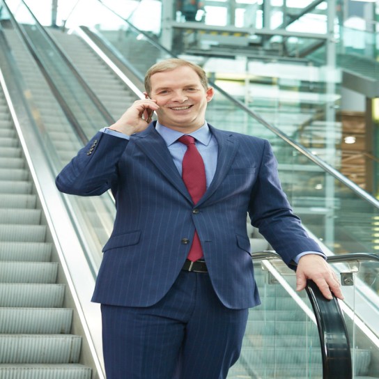 Jon Birrel phoning on a stairmaster