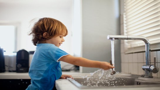 Small boy playing with water
