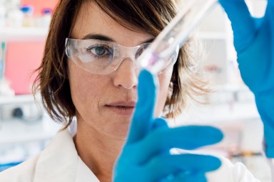 Serious chemist analyzing chemical in test tube